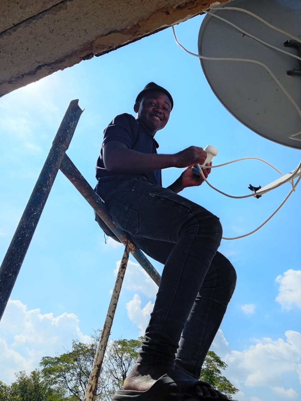 Technician working on a satellite installation
